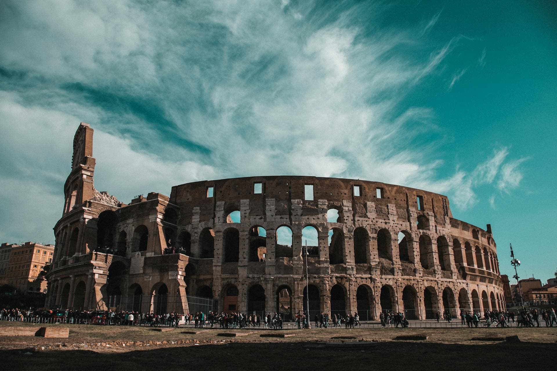 The Colosseum in Rome beneath a dramatic streaked sky