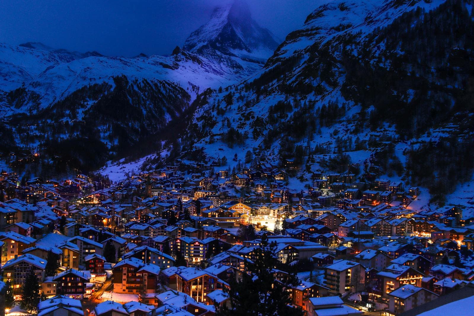 The Hythe Vail in winter, framed by snow-dusted pines and alpine village lights